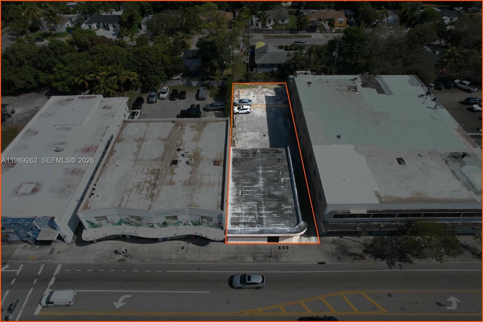 An aerial view shows a narrow commercial building lot outlined in orange between two structures — 8333 NE 2nd Ave, Miami FL 33138, MIAMI, FL