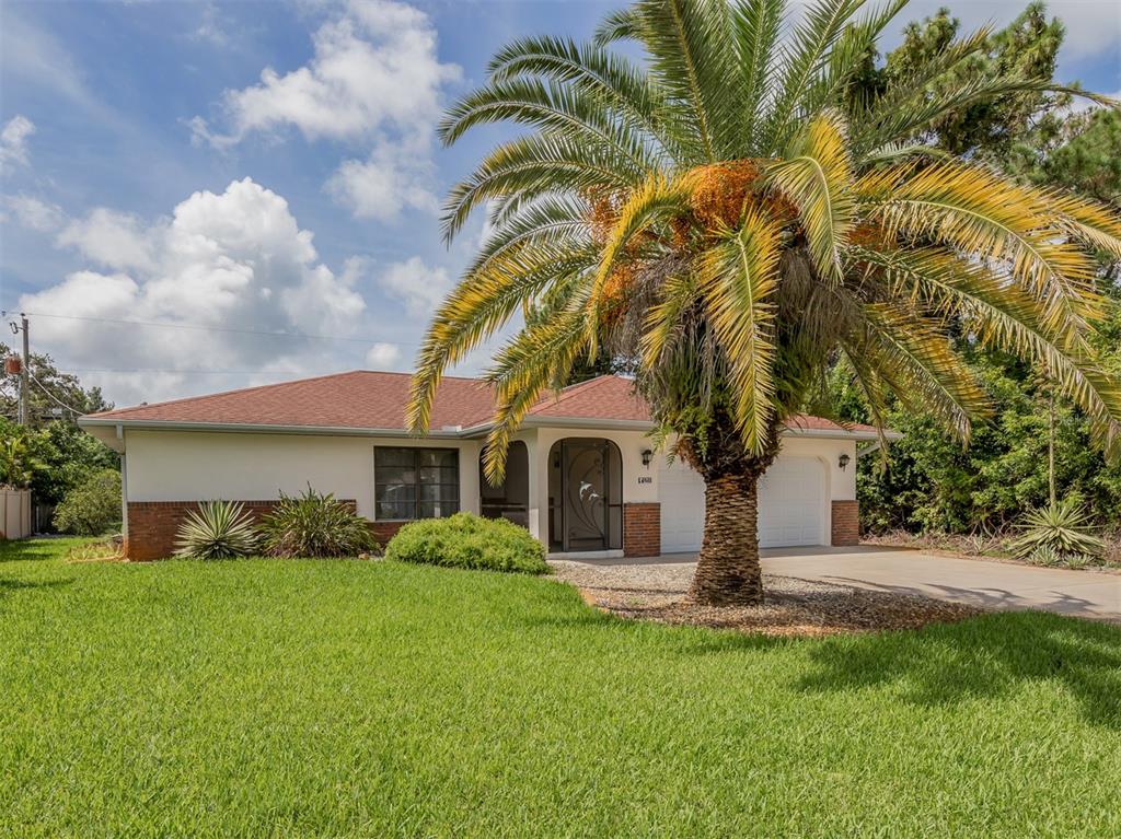 A single-story house with a brick and stucco exterior, a palm tree, and a driveway — 1211 SOUTHLAND ROAD, VENICE, FL