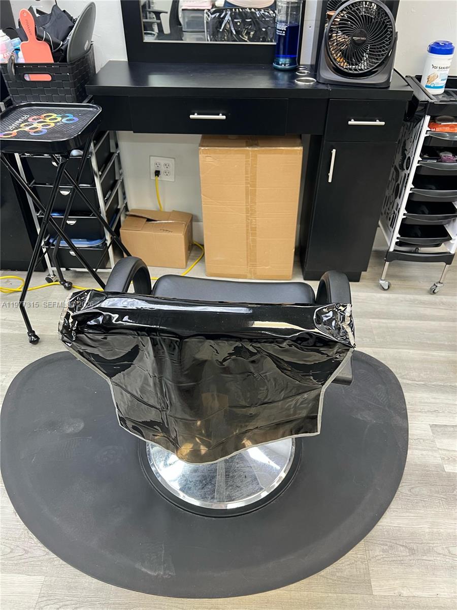 A salon station features a black styling chair, a vanity desk, and storage carts — 3300 E 4 AVE, Hialeah FL 33013, HIALEAH, FL
