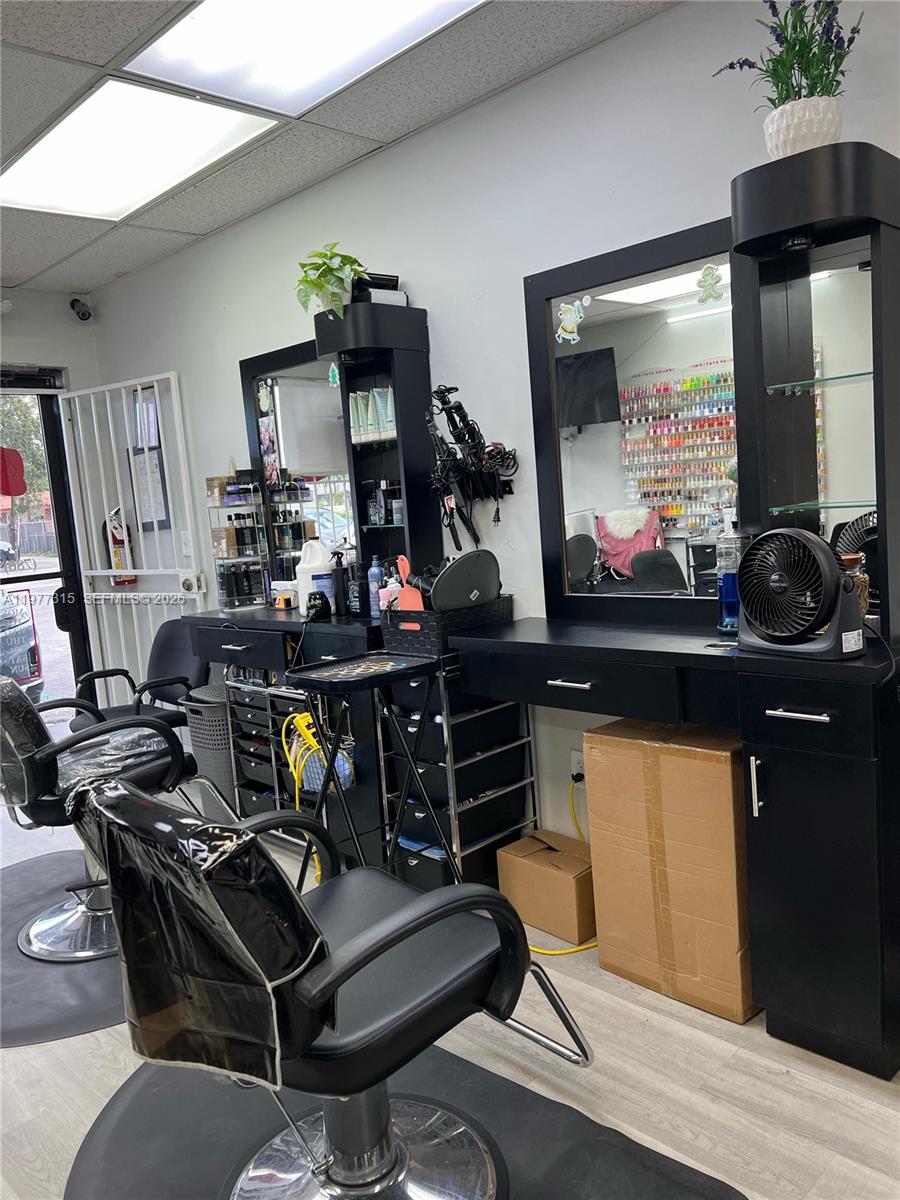 A hair salon features two black styling stations with mirrors, chairs, and storage cabinets — 3300 E 4 AVE, Hialeah FL 33013, HIALEAH, FL