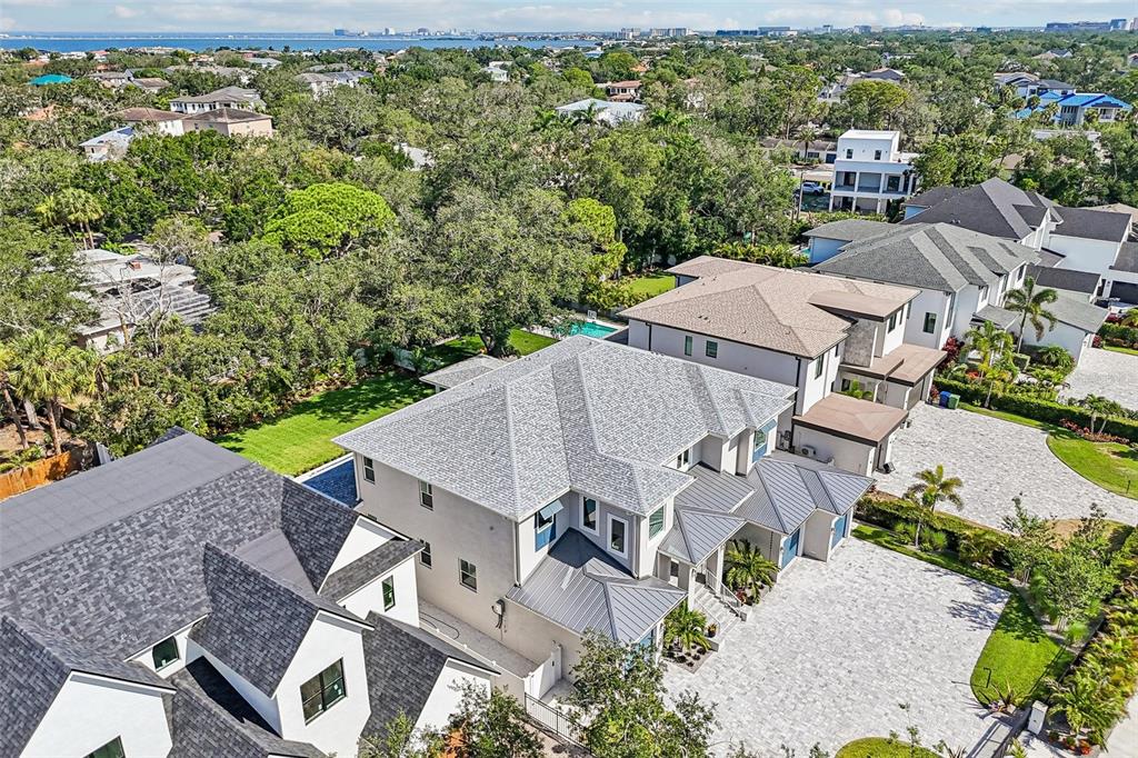 An aerial view shows a large multi-story house with a gray roof and paved driveway — 3013 S WEST SHORE BOULEVARD, TAMPA, FL