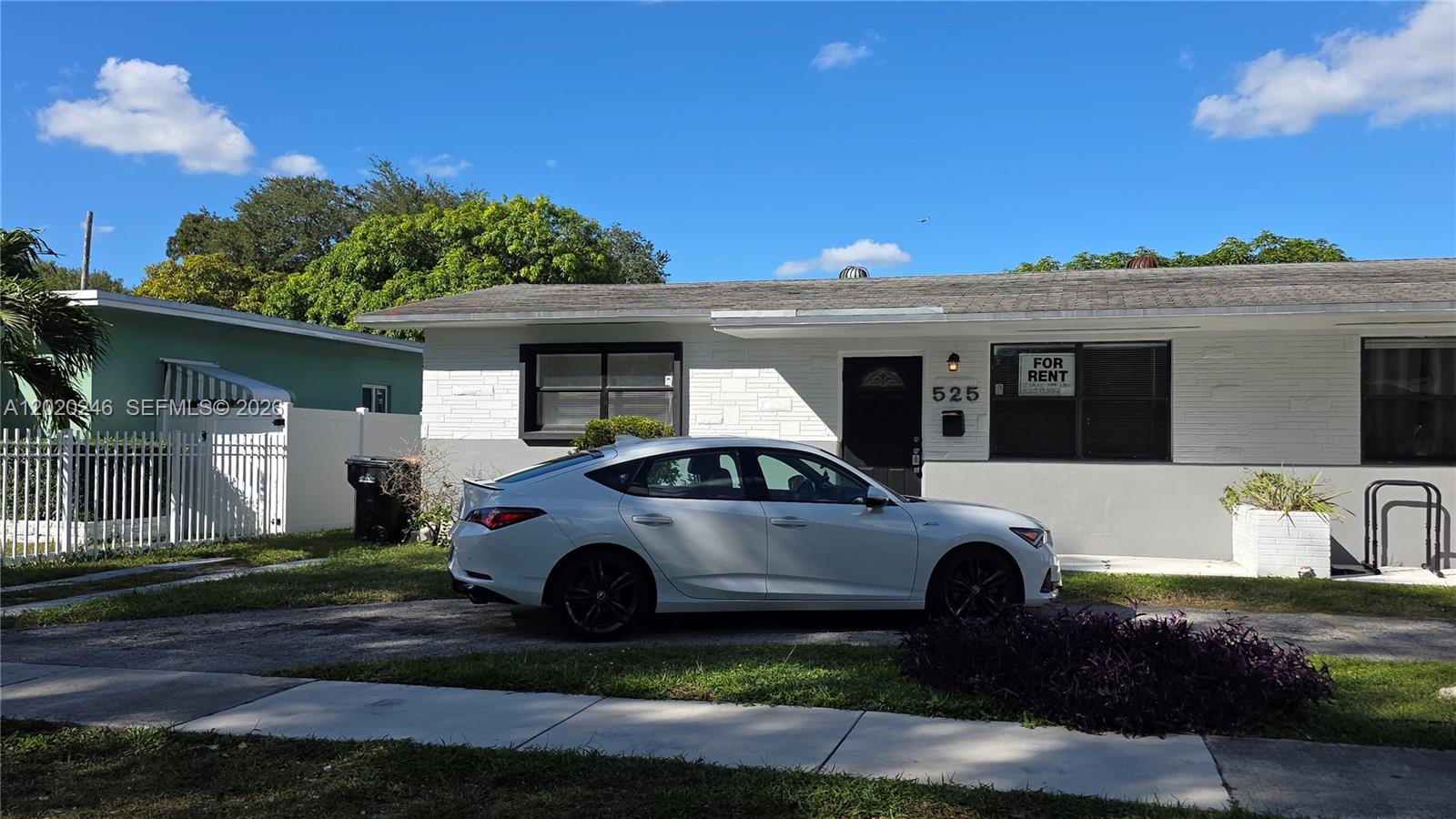 A white single-story house with a driveway and a for rent sign is shown — 525 NE 132nd Ter # 527, North Miami FL 33161, NORTH MIAMI, FL
