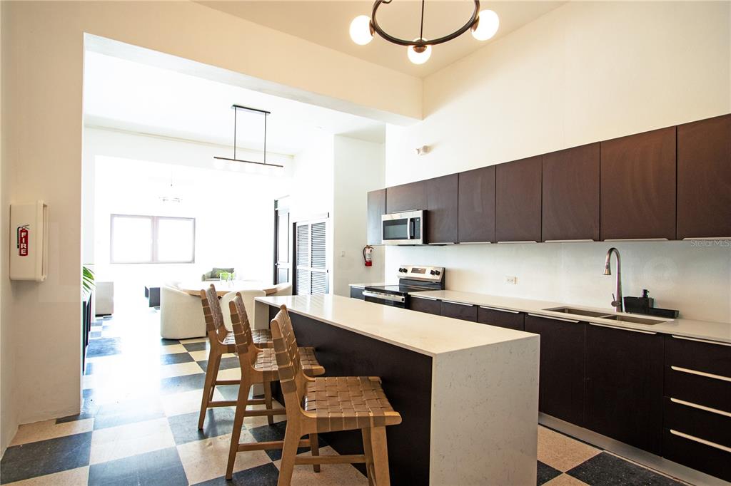 A kitchen with dark cabinets, a white island, and a black-and-white checkered floor — 254-256 SAN FRANCISCO STREET UNIT 203, SAN JUAN, PR
