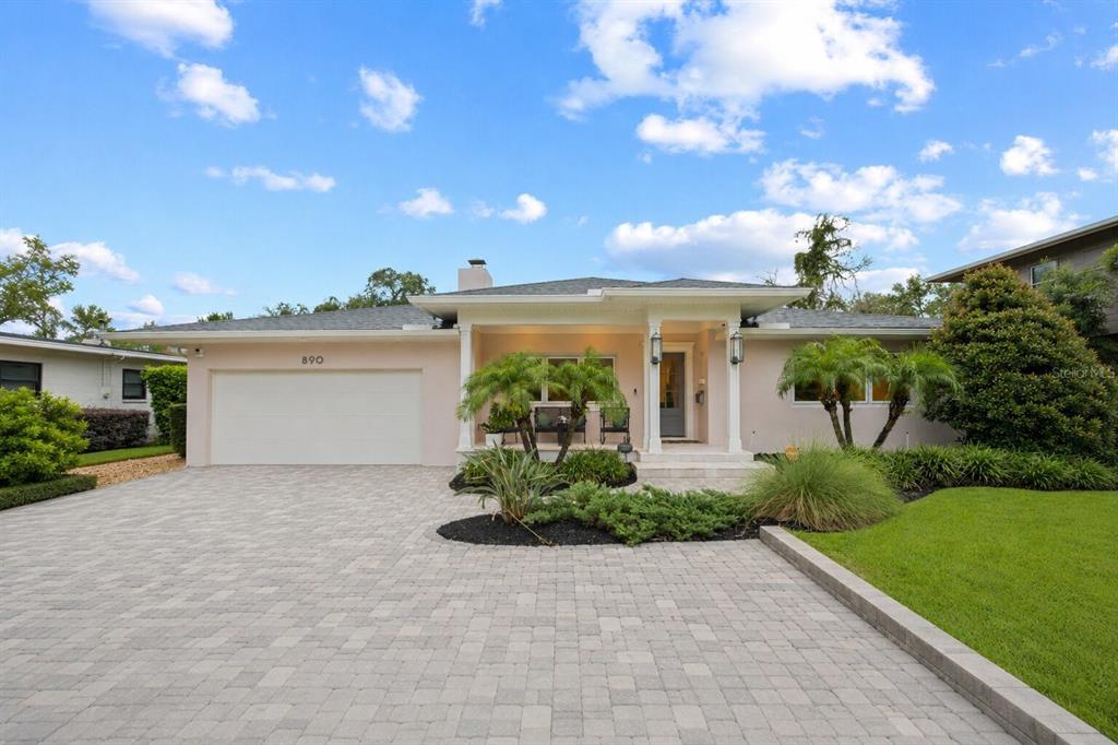 A single-story house with a paved driveway, a two-car garage, and a covered front porch — 890 N PHELPS AVENUE, WINTER PARK, FL