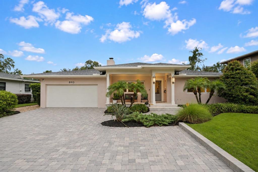 A single-story house with a paved driveway, a two-car garage, and a covered front porch — 890 N PHELPS AVENUE, WINTER PARK, FL