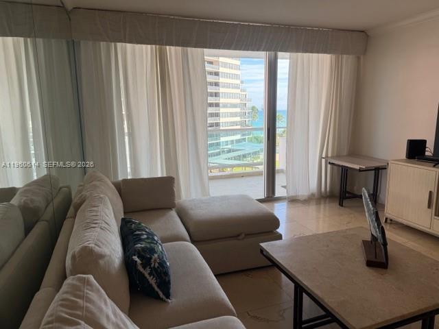 A living room features a beige sectional sofa, a stone coffee table, and floor-to-ceiling windows — 5161 Collins Ave # 703, Miami Beach FL 33140, MIAMI BEACH, FL