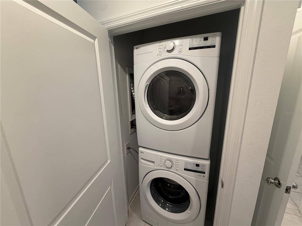 A stacked white LG washer and dryer unit is installed inside a small closet — 314 LAWSON AVENUE UNIT Rear, HAINES CITY, FL