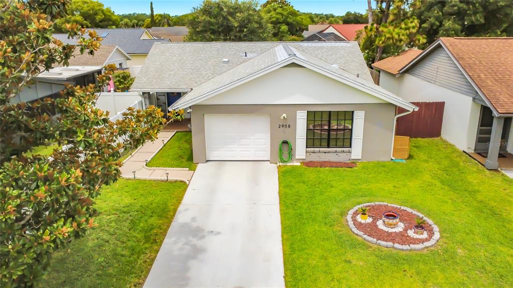 An exterior view of a single-story house with a garage, driveway, and front lawn — 2908 BRIDGEGATE COURT, ORLANDO, FL