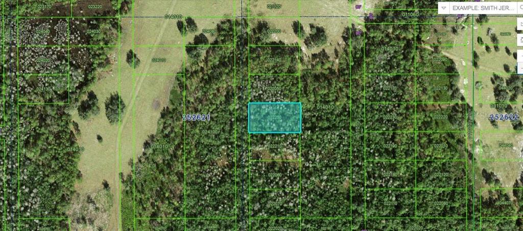 This is a satellite map view showing a highlighted rectangular parcel of land — COMMANWEALTH AVE N, POLK CITY, FL