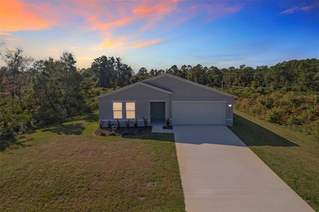 This is a floor plan for a single-story house with three bedrooms and a garage — 810 DARLINGTON AVENUE SW, PALM BAY, FL