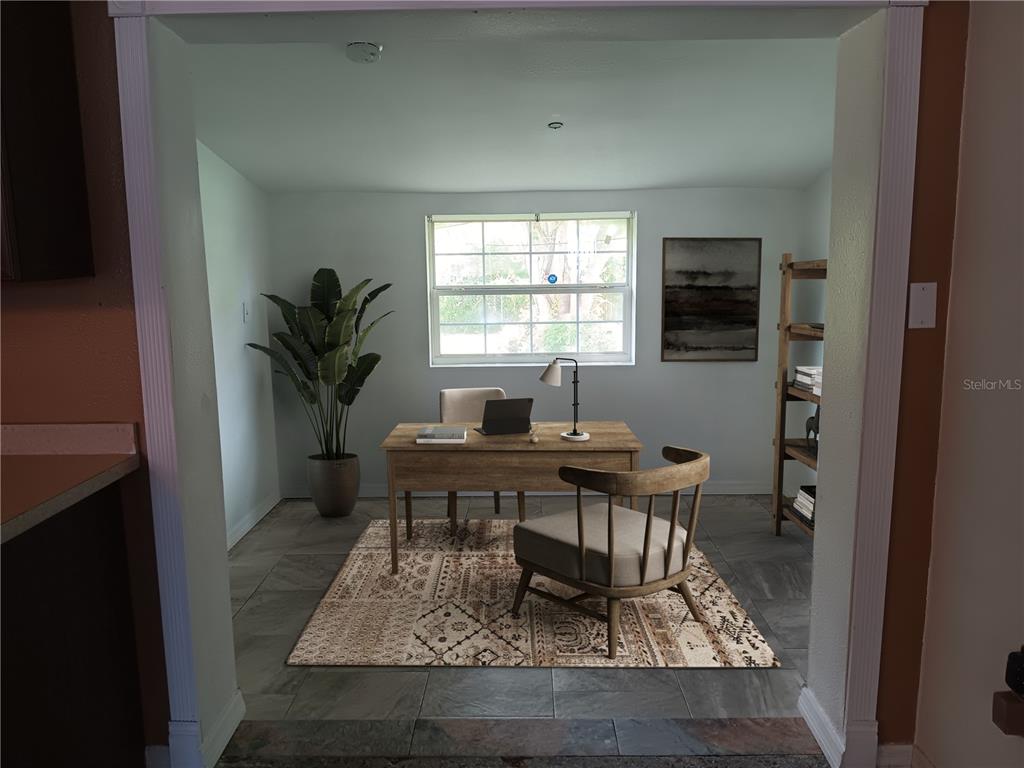A home office features a wooden desk, a patterned rug, and a large window — 2103 MANTILLA AVENUE, ORLANDO, FL