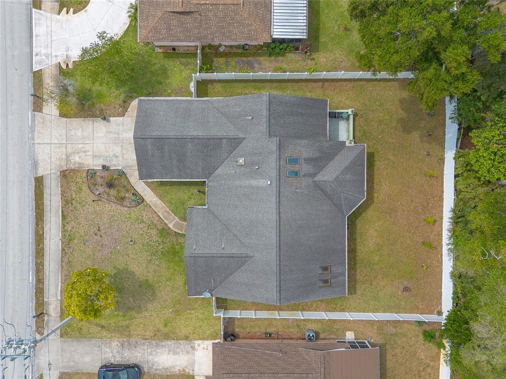 An aerial view shows a residential house with a gray shingled roof and fenced yard — 50 FLORIDA PARK DRIVE, PALM COAST, FL
