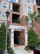 An exterior view of a multi-story apartment building with a staircase leading to an entrance — 1357 VENEZIA COURT UNIT 302, DAVENPORT, FL