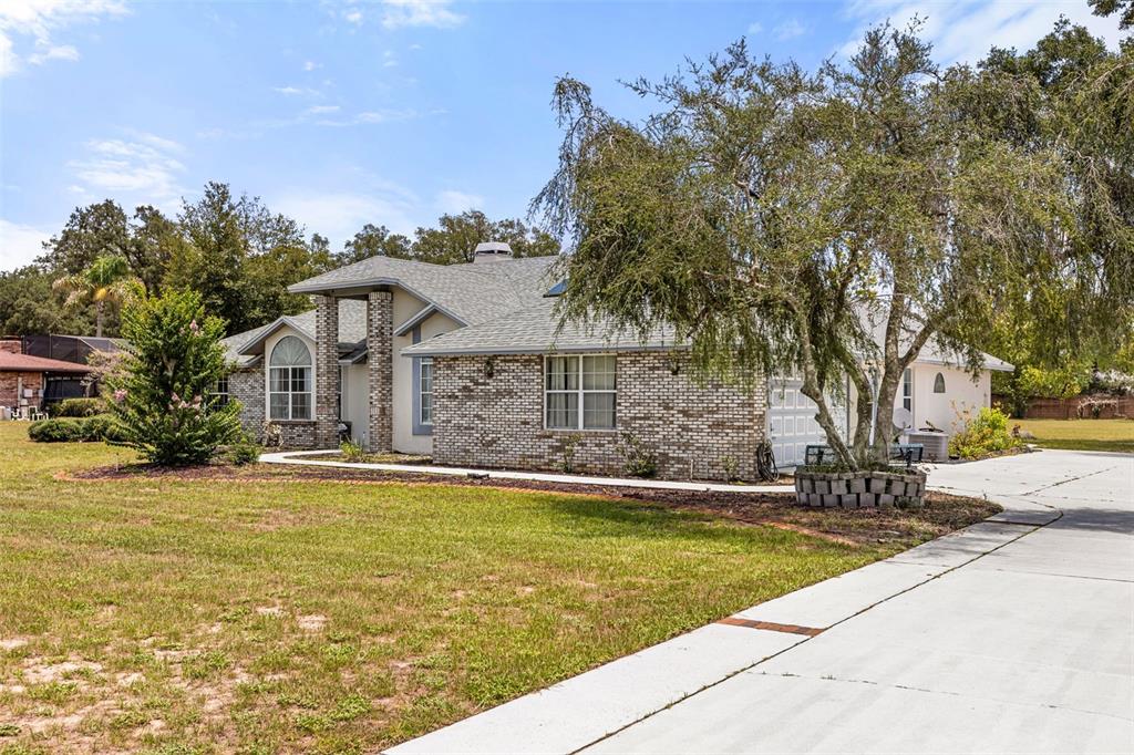 A single-story brick house with a gray shingled roof and a concrete driveway — 6231 ALBETH ROAD, ORLANDO, FL