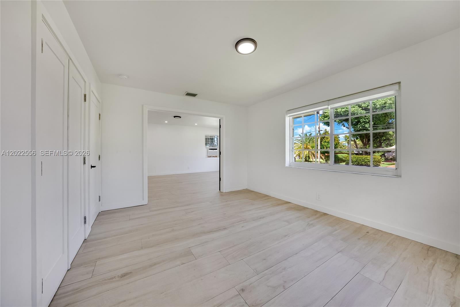A white, single-story house with a blue front door and a flat roof — 716 SW 5th Ave, Hallandale Beach FL 33009, HALLANDALE BEACH, FL