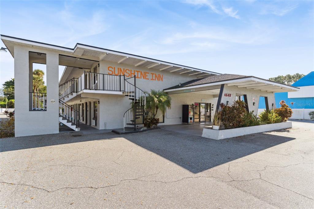 A two-story motel building with a spiral staircase, balcony, and a covered entrance — 4643 W IRLO BRONSON MEMORIAL HIGHWAY, KISSIMMEE, FL