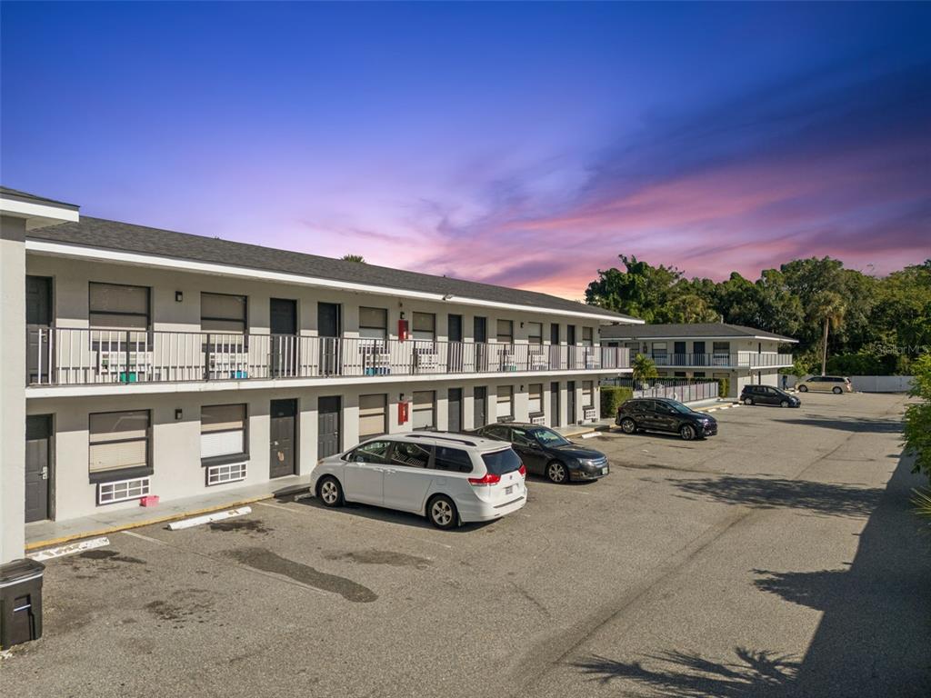 A two-story apartment building with exterior walkways and a parking lot in front — 4643 W IRLO BRONSON MEMORIAL HIGHWAY, KISSIMMEE, FL