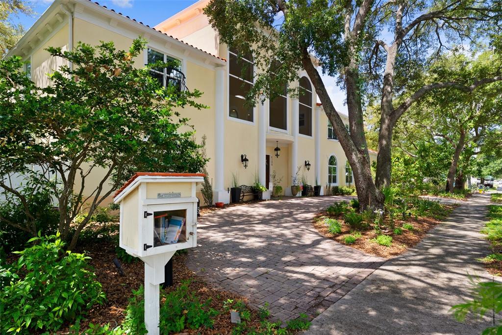 A two-story yellow house features a central entrance with columns and three arched windows — 4106 W SAN MIGUEL STREET, TAMPA, FL