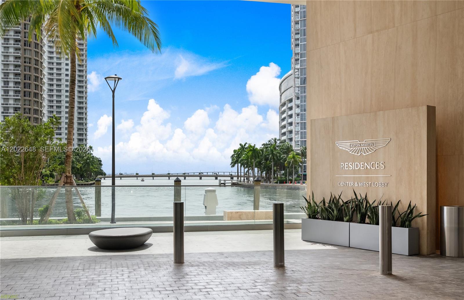 A waterfront view from the Aston Martin Residences lobby featuring a paved patio and bollards — 300 Biscayne Blvd Way # 3604, Miami FL 33131, MIAMI, FL