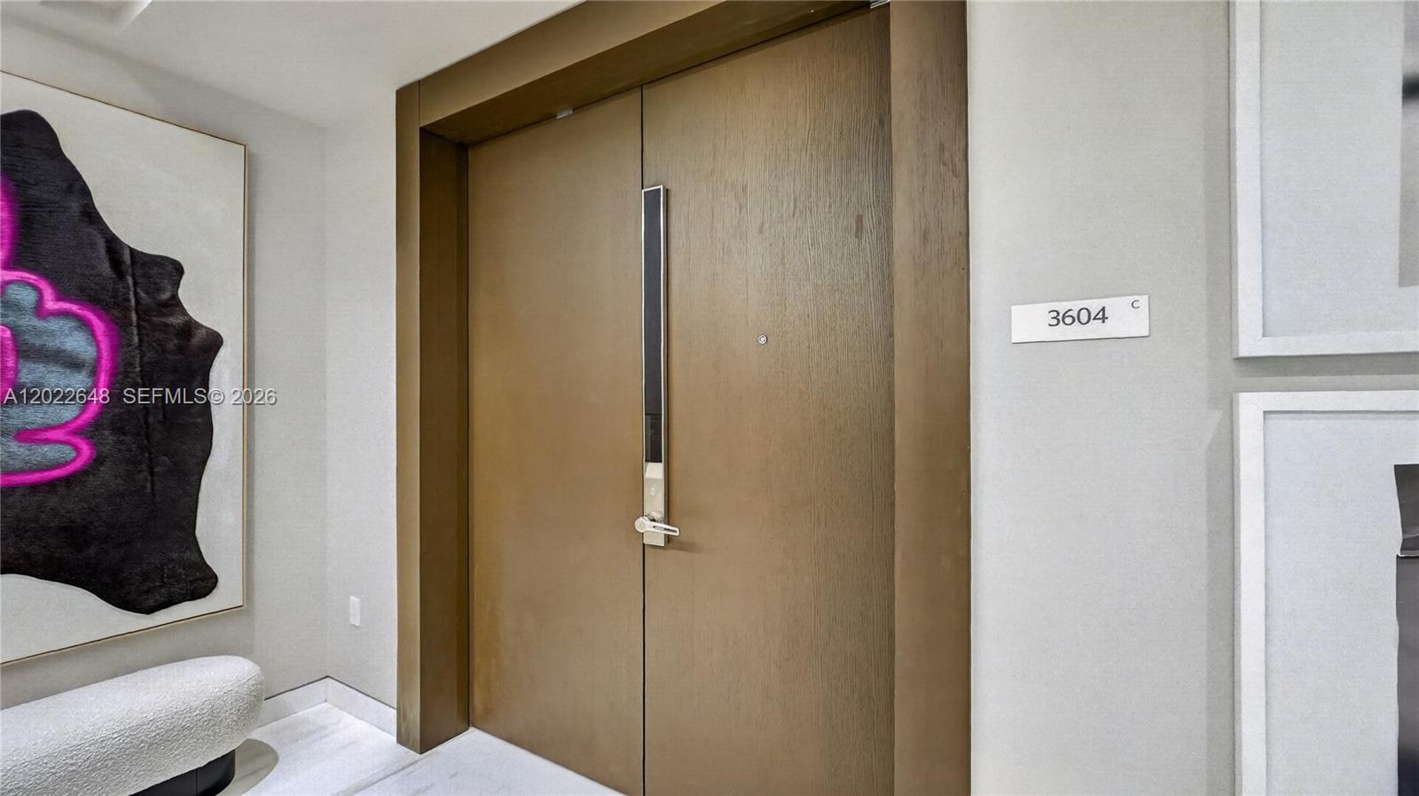 A modern double door with a vertical handle is set in a light-colored hallway — 300 Biscayne Blvd Way # 3604, Miami FL 33131, MIAMI, FL