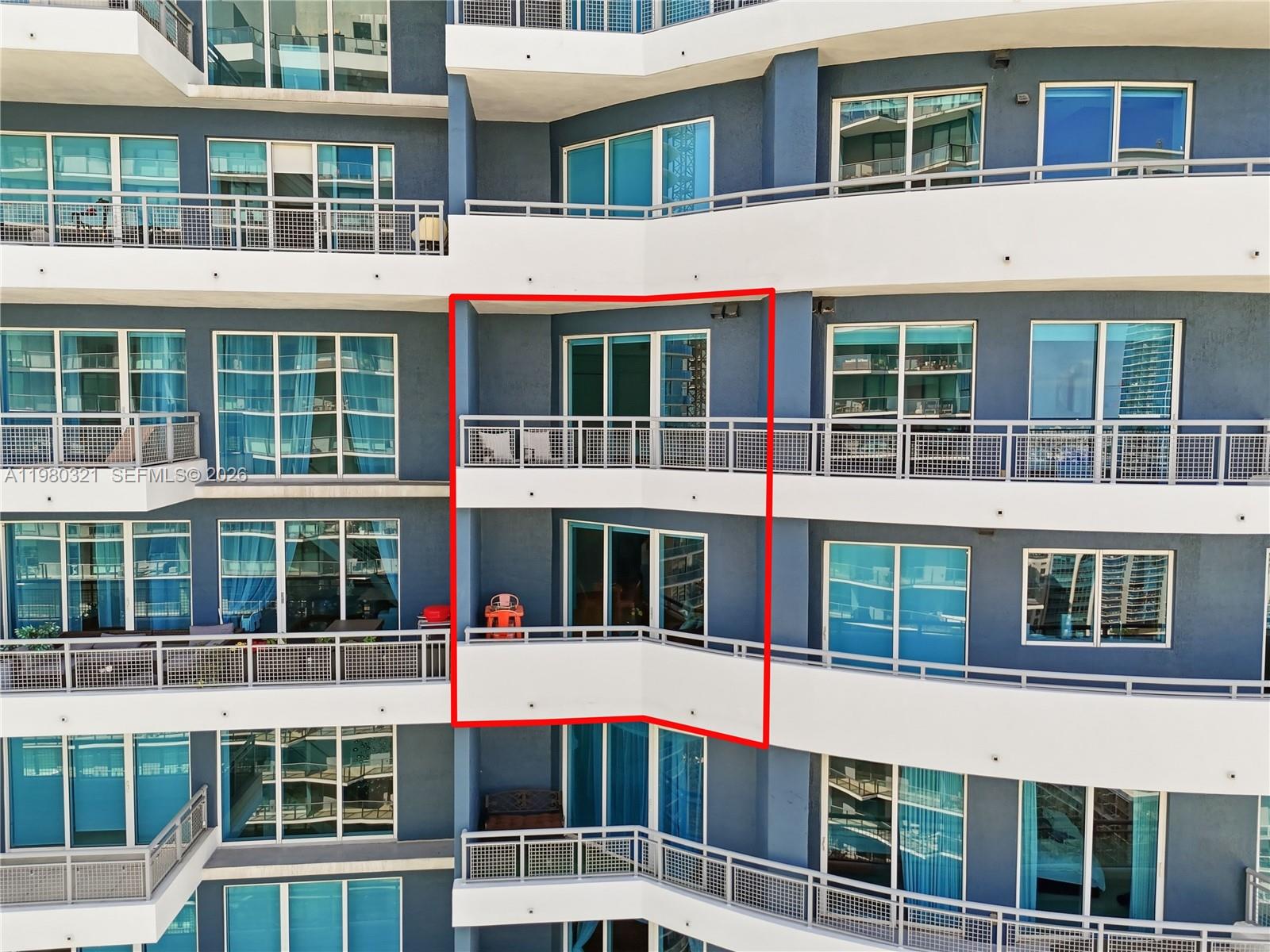 This exterior view shows a multi-story building with blue walls and private balconies — 60 SW 13th St # 4414, Miami FL 33130, MIAMI, FL