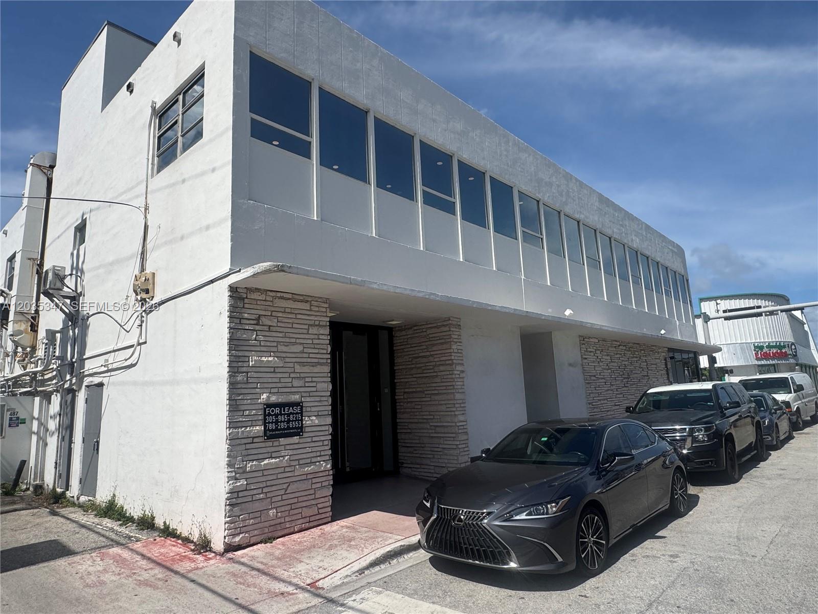 A two-story white commercial building with stone accents and a row of parked cars — 9491 Harding Ave # 205, Surfside FL 33154, SURFSIDE, FL