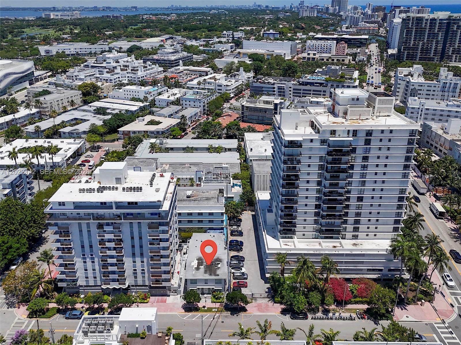 An aerial view shows a low-rise building marked with a pin between two high-rise towers — 235 18th St, Miami Beach FL 33139, MIAMI BEACH, FL