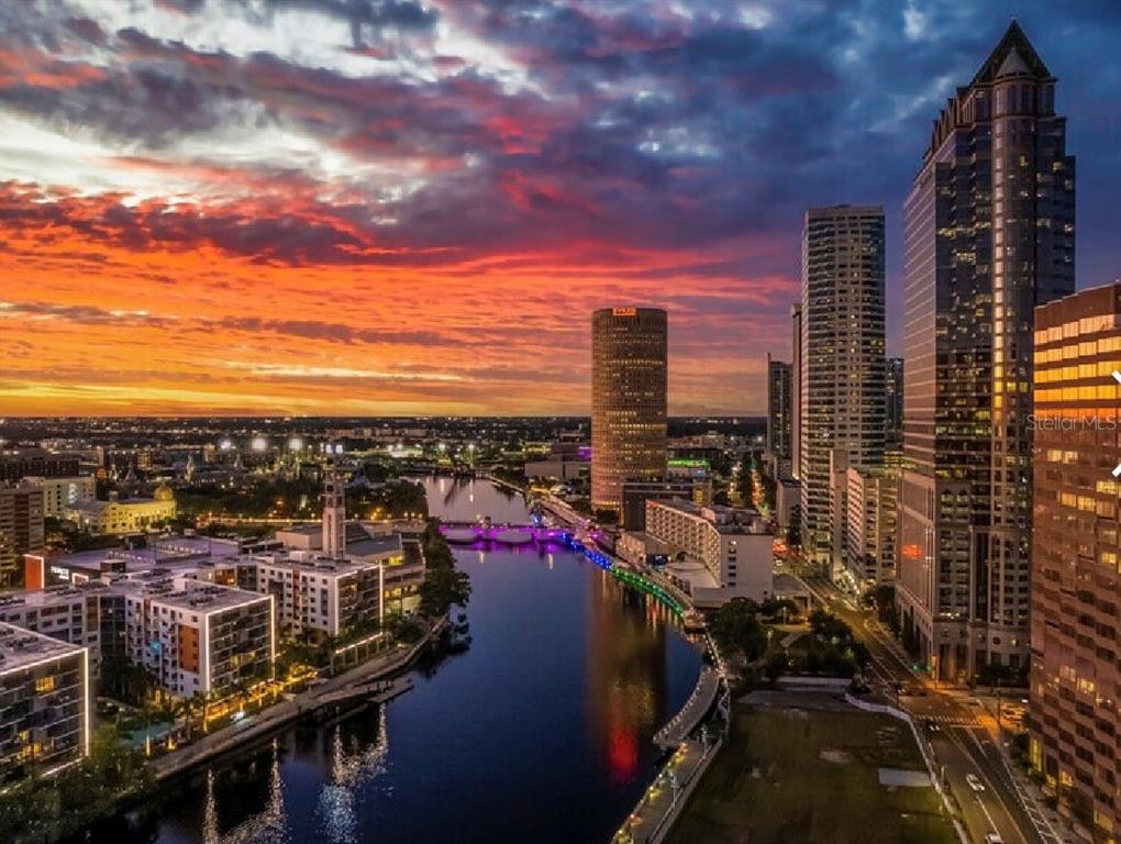 An aerial view of the Tampa skyline at sunset featuring the Hillsborough River and skyscrapers — 400 N ASHLEY DRIVE UNIT 2050, TAMPA, FL