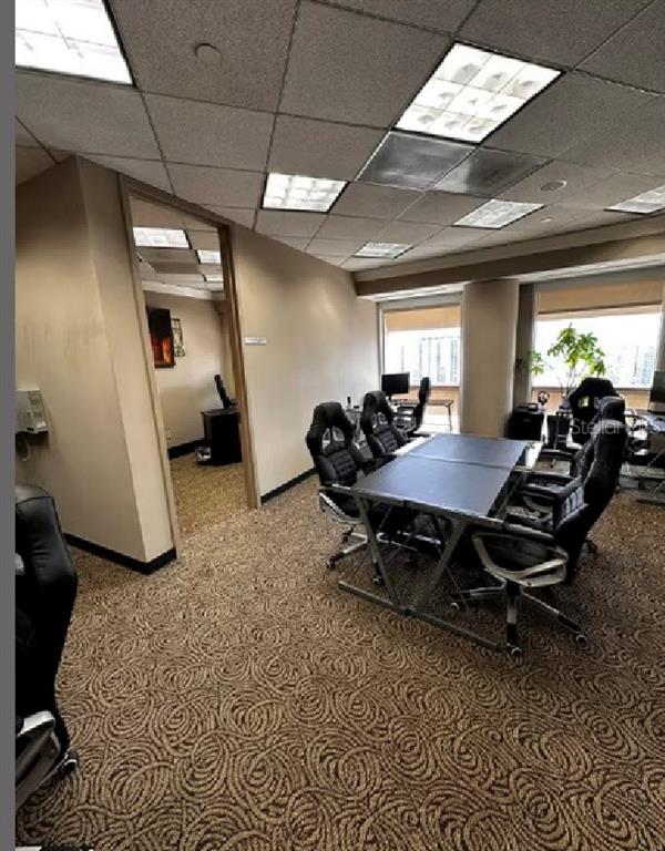 An office space features a conference table with gaming chairs and patterned carpeting — 400 N ASHLEY DRIVE UNIT 2050, TAMPA, FL