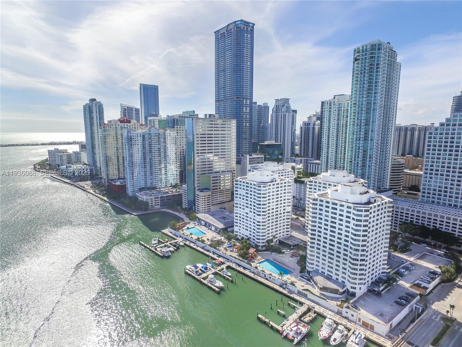 An aerial view of a Miami waterfront skyline featuring high-rise buildings and a private marina — 825 Brickell Bay Dr, Miami FL 33131, MIAMI, FL