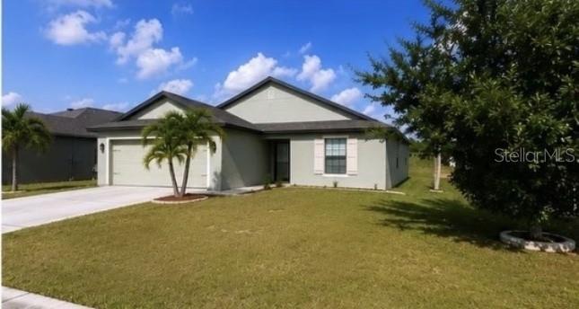 A single-story house with a light-colored exterior, a two-car garage, and a front lawn — 171 SHADOWVIEW COURT, LEHIGH ACRES, FL
