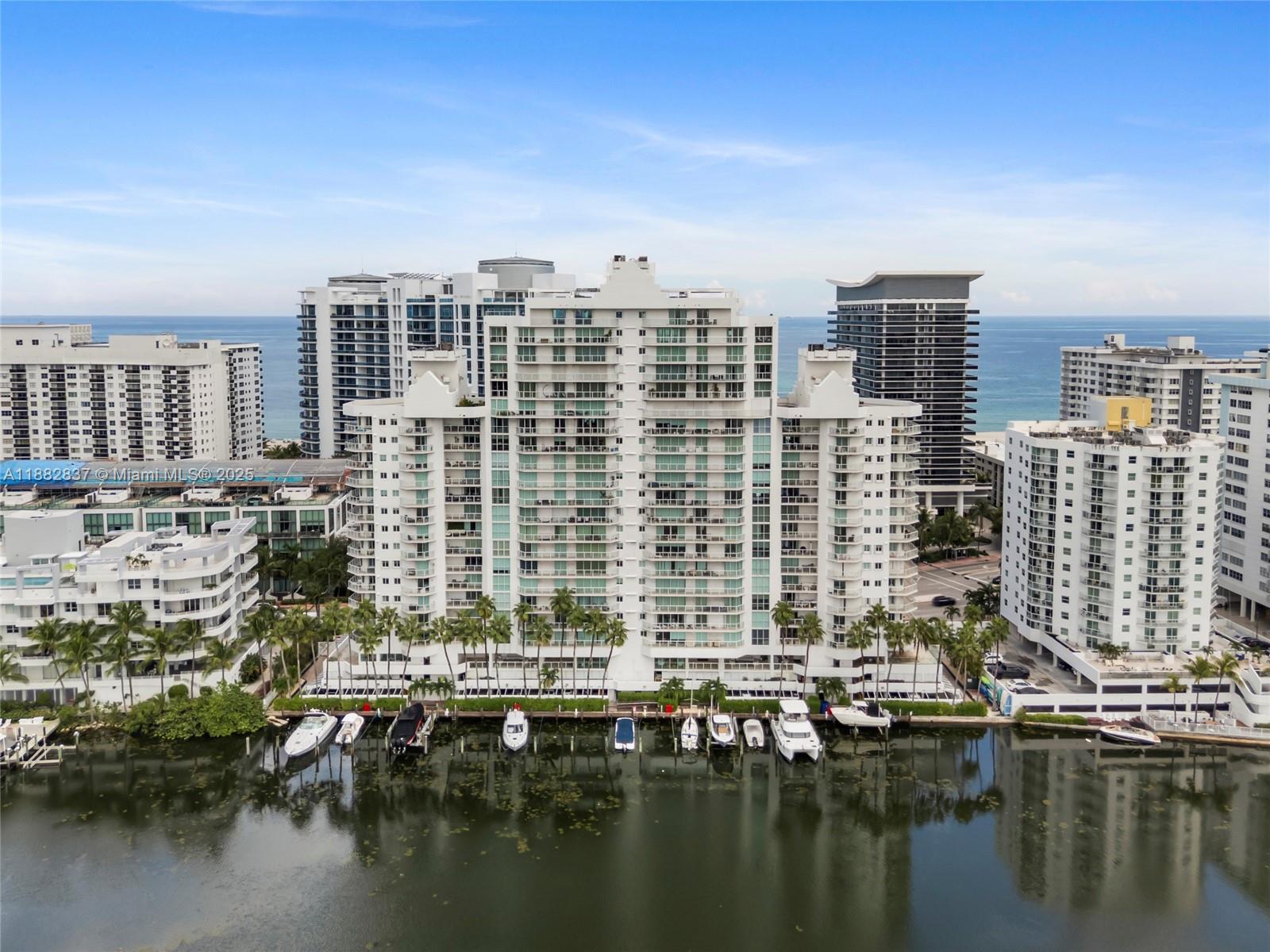 An aerial view of a multi-story residential building with a private boat dock — 5900 Collins Ave # 604, Miami Beach FL 33140, MIAMI BEACH, FL