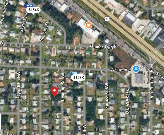 This is a satellite map view showing a residential neighborhood with a highlighted property location — 558 READING STREET NW, PORT CHARLOTTE, FL