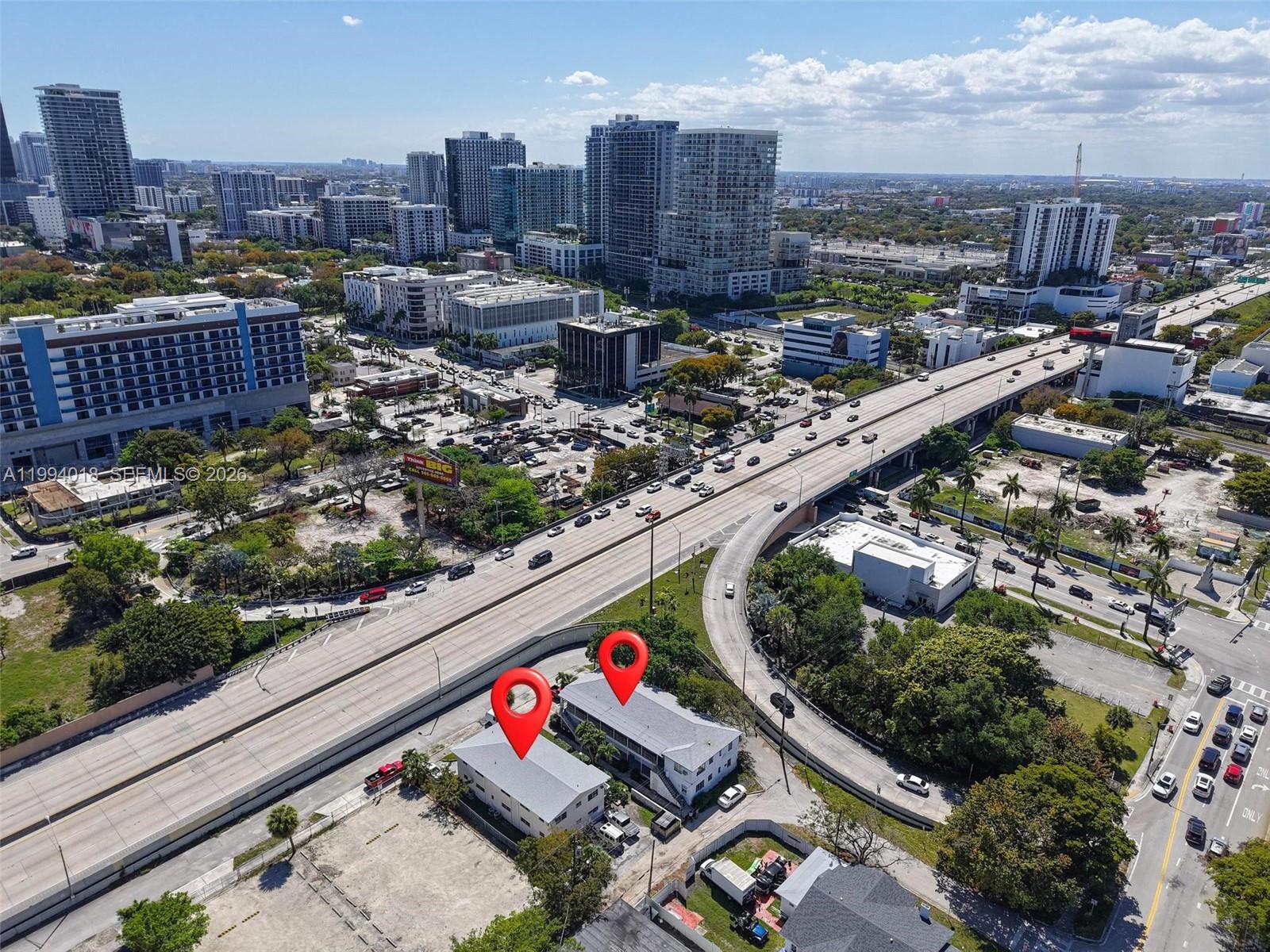 An aerial view shows two adjacent residential buildings situated next to an elevated highway — 433 NE 37th St, Miami FL 33137, MIAMI, FL