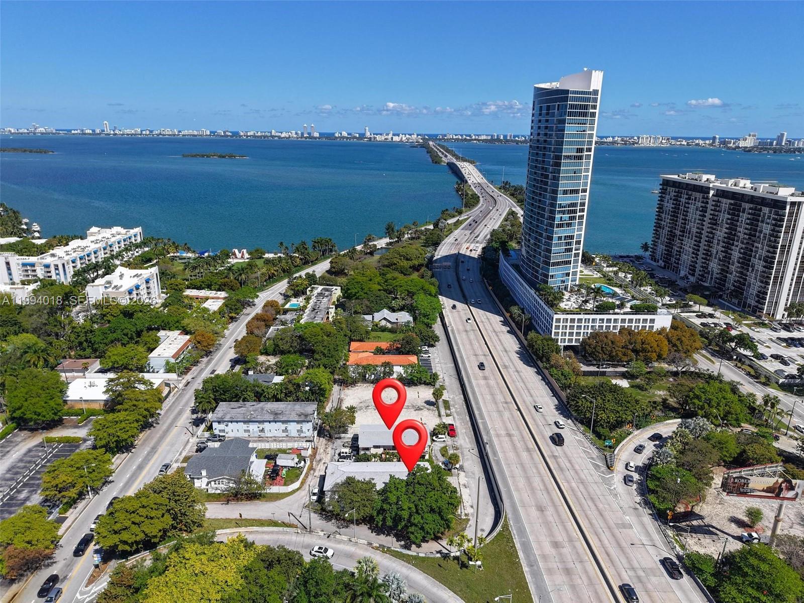 An aerial view shows a property lot marked with pins next to a highway bridge — 433 NE 37th St, Miami FL 33137, MIAMI, FL
