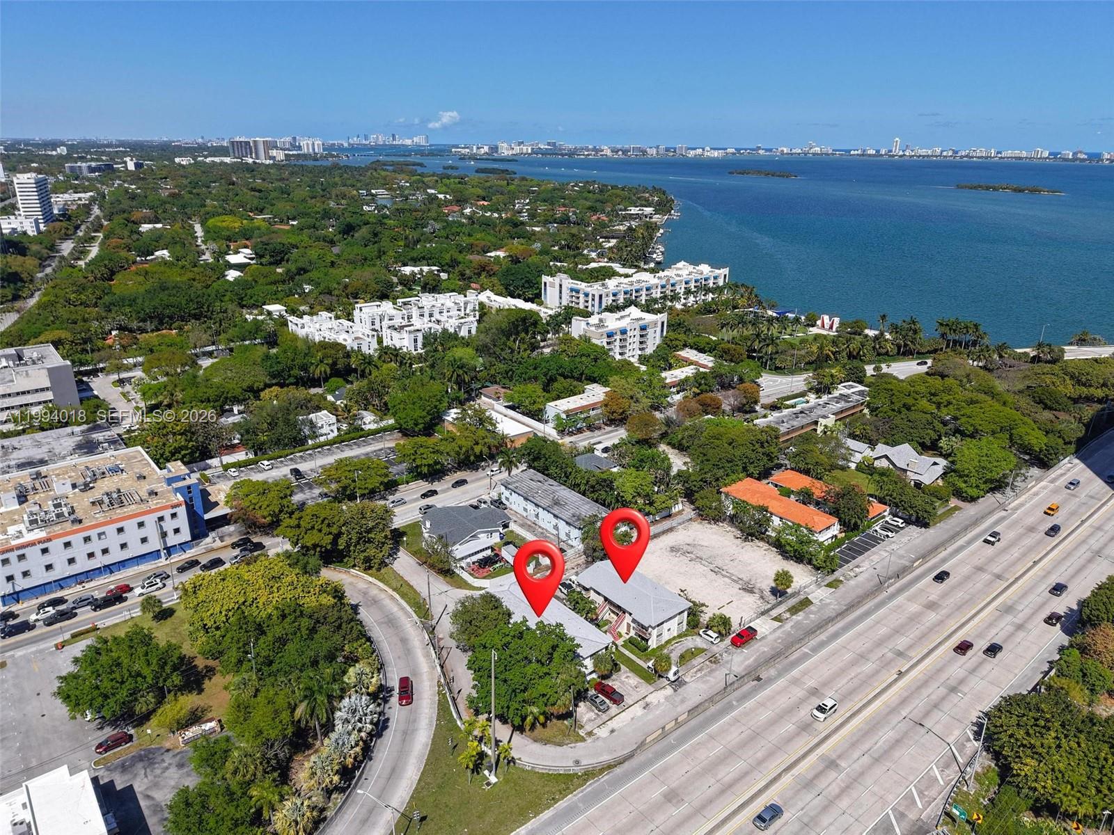 An aerial view shows two adjacent residential buildings located next to a major highway — 433 NE 37th St, Miami FL 33137, MIAMI, FL