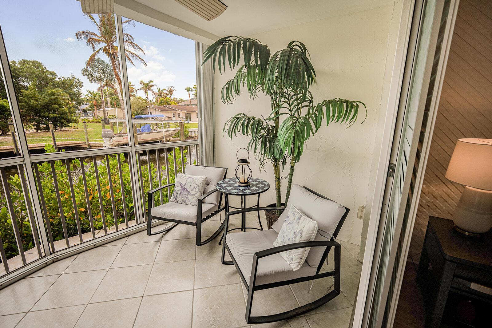 View of a canal with docked boats from a screened-in porch — 3901 SE Saint Lucie Boulevard # 13, Stuart FL 34997, STUART, FL