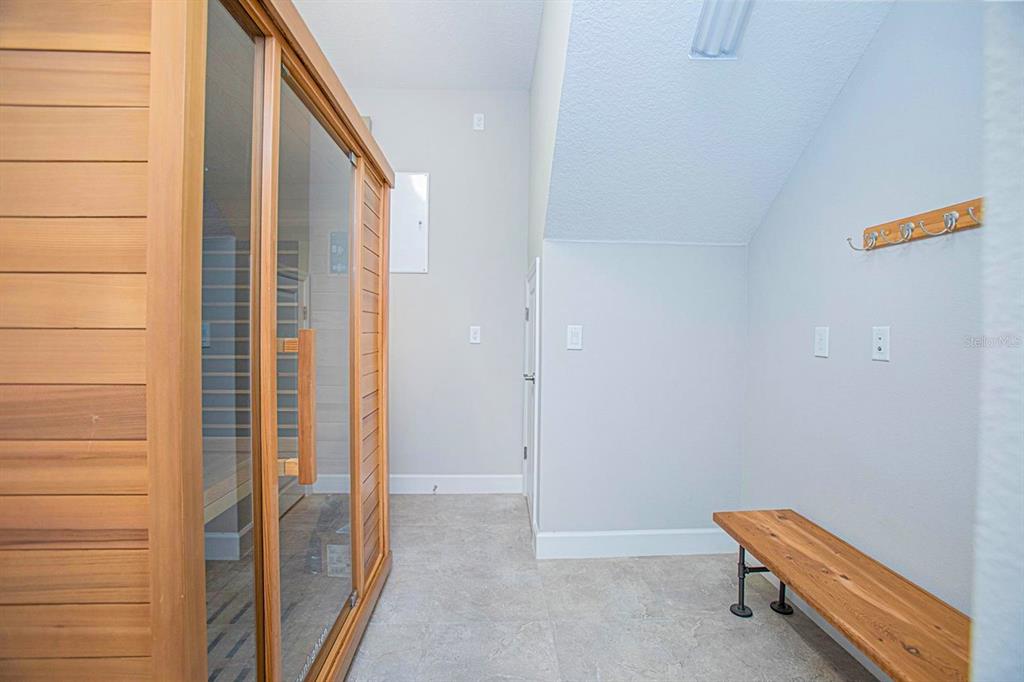 A room with a wooden sauna, a bench, and a coat rack on the wall — 13413 GRANGER AVENUE, ORLANDO, FL
