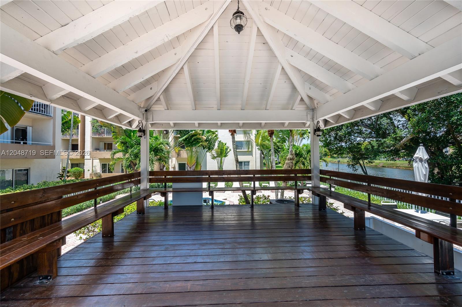 A kitchen features white cabinetry, stainless steel appliances, and light-colored tile flooring — 7705 SW 86th St # 114, Miami FL 33143, MIAMI, FL