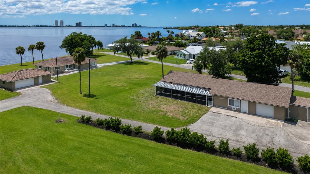 An aerial view shows two houses on a large grassy lot near a body of water — 1818/1822 STEVENSON ROAD, NORTH FORT MYERS, FL