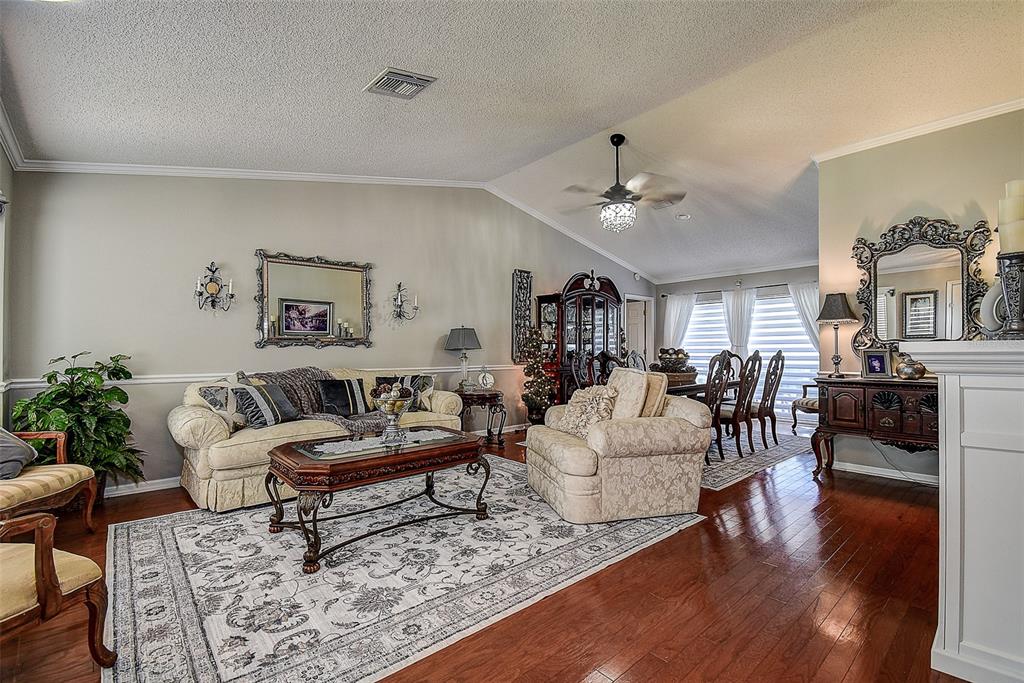 A living room with hardwood floors, a patterned area rug, and traditional furniture — 18624 GRAND CLUB DRIVE, HUDSON, FL