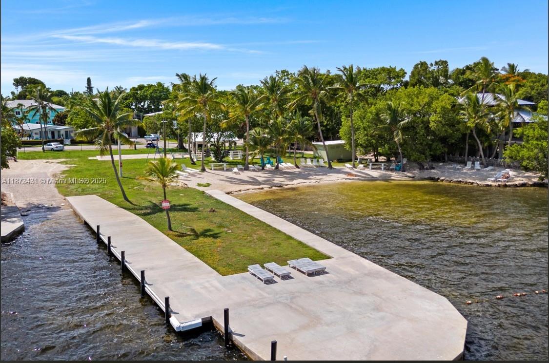 An aerial view of a concrete pier extending into the water near a sandy beach — 53 Bonefish Ave, Key Largo FL 33037, KEY LARGO, FL