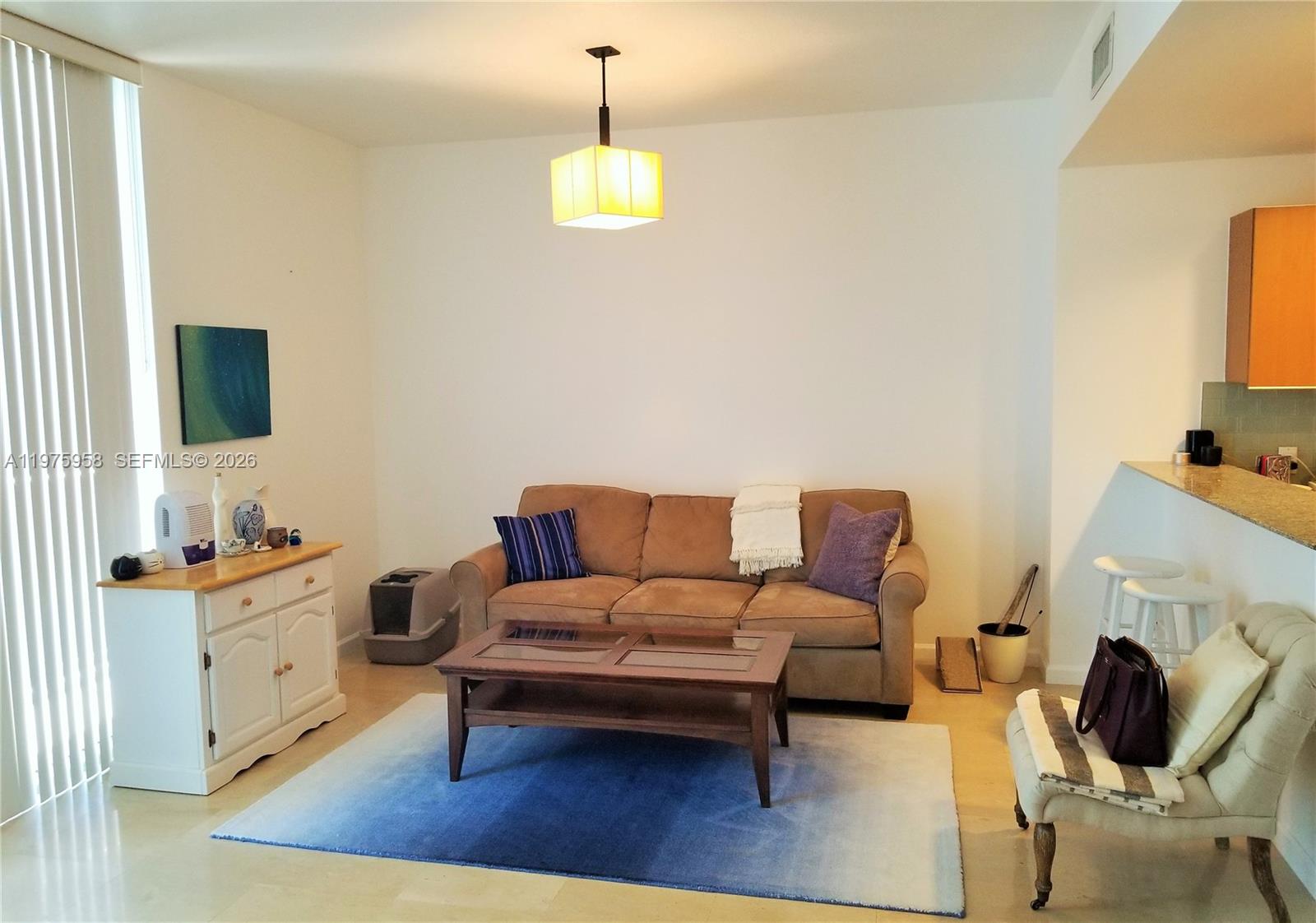 A living room features a brown sofa, a coffee table, and a blue area rug — 1050 BRICKELL AV # 2622, Miami FL 33131, MIAMI, FL