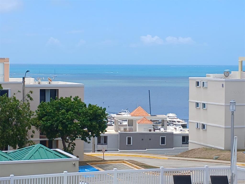 A view of a marina and the ocean from between two multi-story apartment buildings — Ave 400-A VISTA REAL UNIT 7-8, FAJARDO, PR
