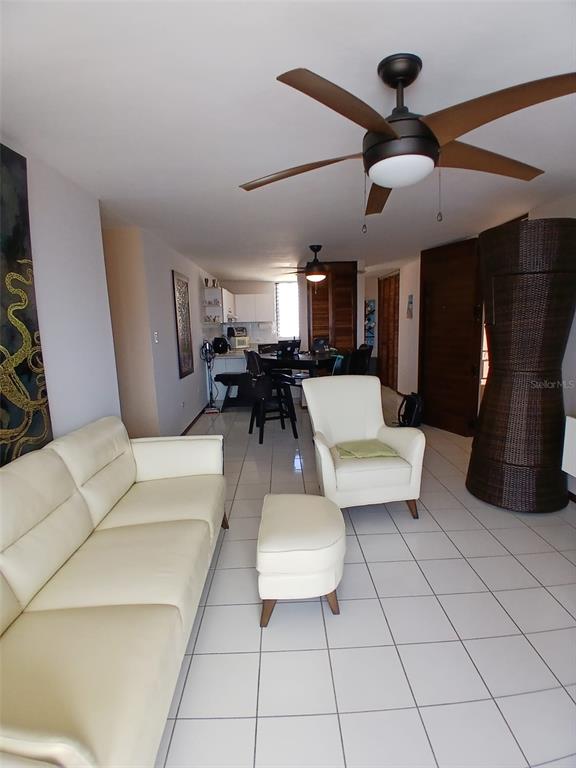 A living room with white tile floors, a cream sofa, an armchair, and a ceiling fan — Ave 400-A VISTA REAL UNIT 7-8, FAJARDO, PR