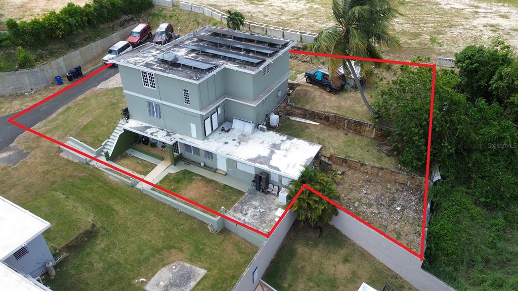 An aerial view of a two-story house with solar panels on a flat roof — PR-107 KM 2.2 INT CALLE SAN JOSE, AGUADILLA, PR