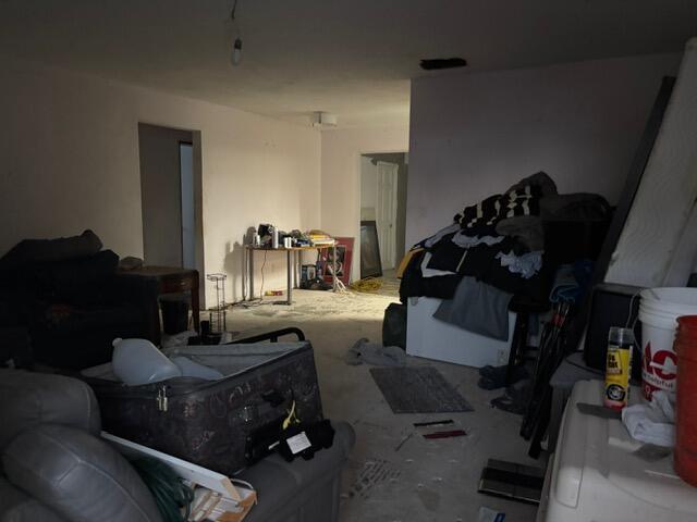 An interior view of a cluttered, unfinished room with bare concrete floors and white walls — 360 Leisure Boulevard, Pompano Beach FL 33064, POMPANO BEACH, FL