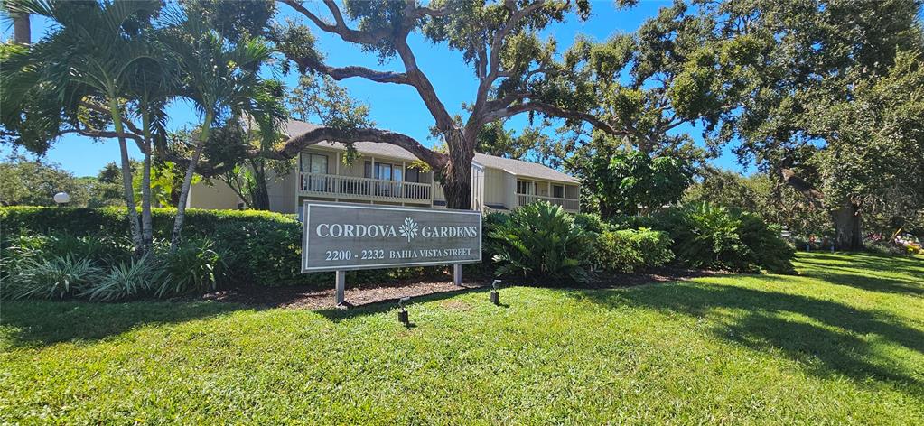 A sign for Cordova Gardens stands in front of a two-story apartment building with trees — 2232 BAHIA VISTA STREET UNIT A6, SARASOTA, FL