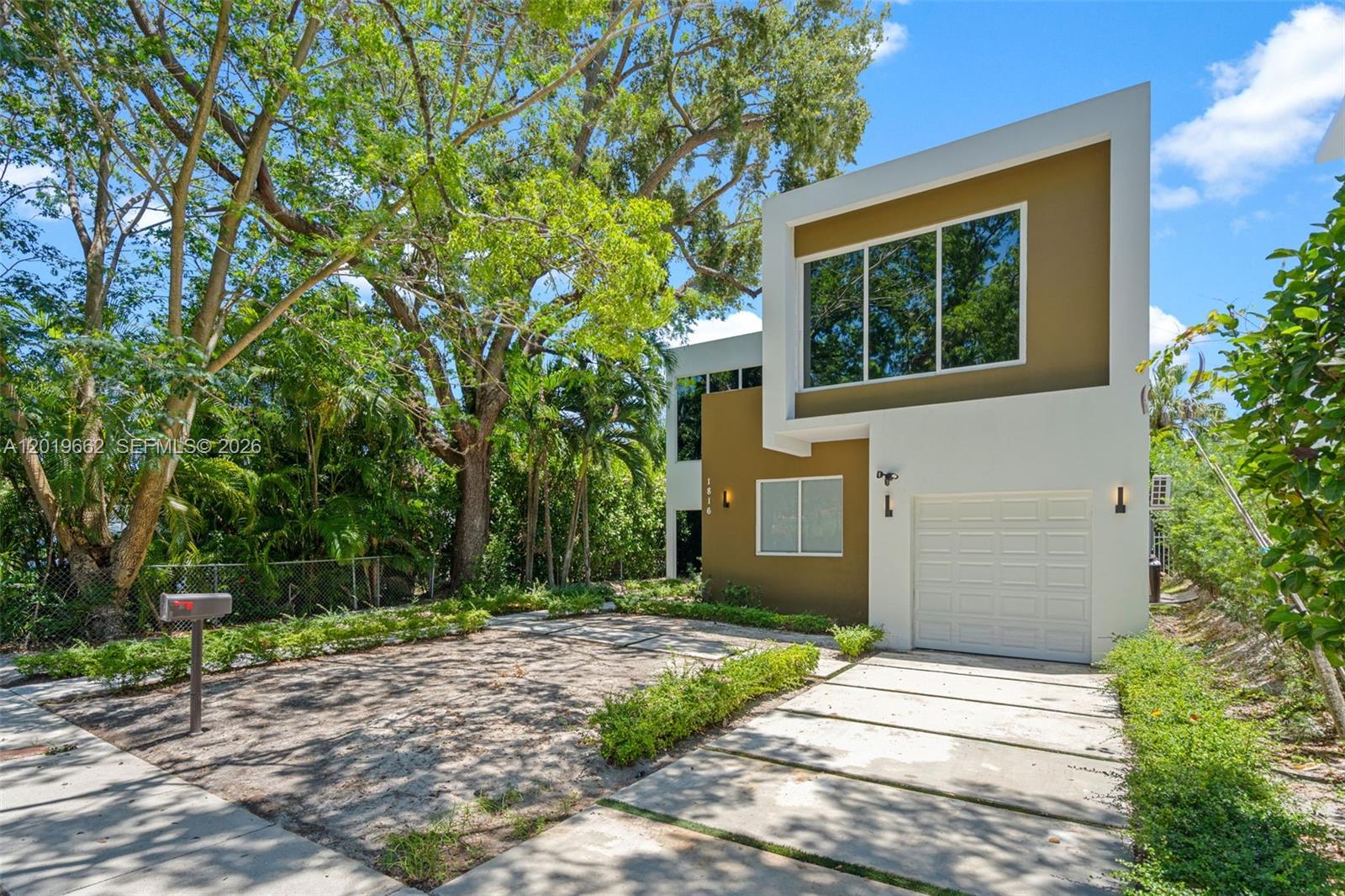 A modern two-story house with a white and tan exterior, a garage, and a driveway — 1816 SW 23rd St, Miami FL 33145, MIAMI, FL