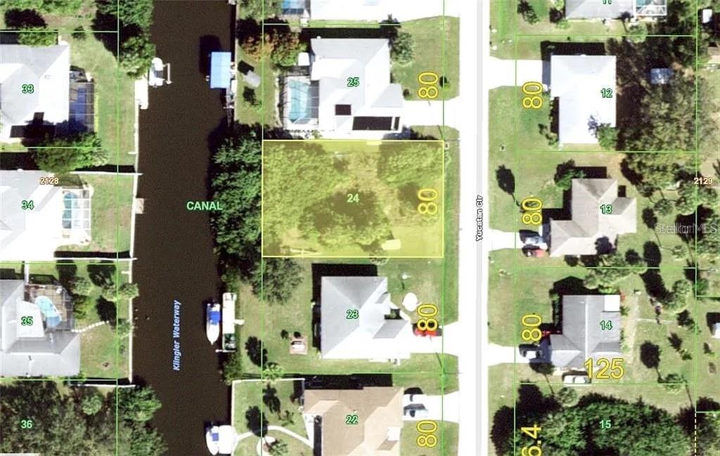 This is an aerial map showing a vacant residential lot highlighted in yellow — 4194 YUCATAN CIRCLE, PORT CHARLOTTE, FL